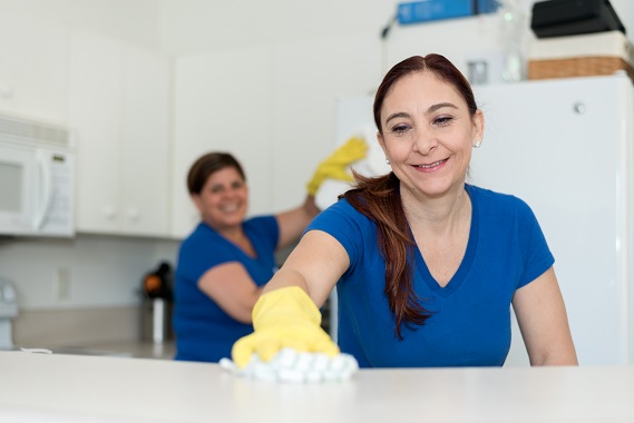 Two janitors cleaning a kitchen
